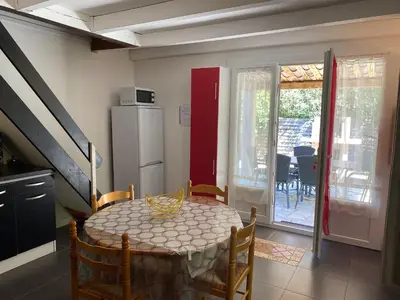 a kitchen and dining room with a table and chairs at Résidence Anitrella in Porto-Vecchio