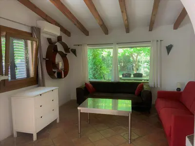 a living room with a couch and a table at Résidence Anitrella in Porto-Vecchio