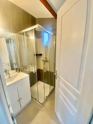 a bathroom with a glass shower and a sink at Résidence Anitrella in Porto-Vecchio