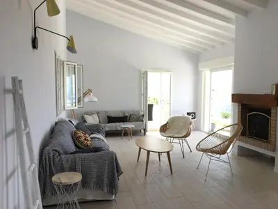 a living room with a couch and a fireplace at Superb sea view villa with pool and big garden in Pietrosella