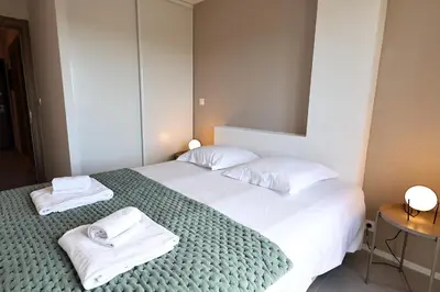 a bedroom with two beds with towels on them at L'Envol - T3 vue mer avec piscine et plage privée in Pianottoli-Caldarello