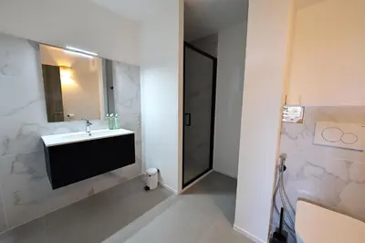 a bathroom with a sink and a mirror at L'Envol - T3 vue mer avec piscine et plage privée in Pianottoli-Caldarello