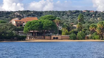 a house on the shore of a body of water at L'Envol - T3 vue mer avec piscine et plage privée in Pianottoli-Caldarello
