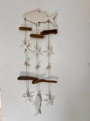 a chandelier hanging on a wall with stars at Logement A Nepita splendide vue mer avec piscine in Porto-Vecchio
