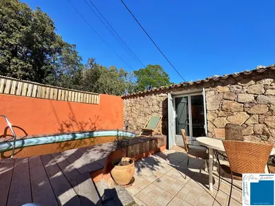 a patio with a pool and a table and chairs at VILLA HORUS - Bergerie 1chambre - piscine privée in San-Gavino-di-Carbini