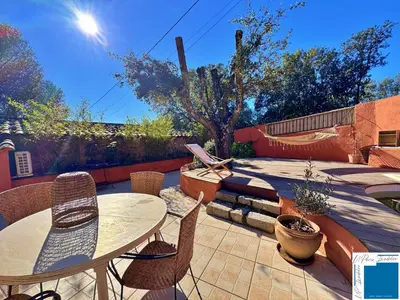 a patio with a table and chairs and a playground at VILLA HORUS - Bergerie 1chambre - piscine privée in San-Gavino-di-Carbini