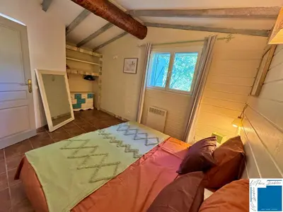 a room with a bed in a room with a window at VILLA HORUS - Bergerie 1chambre - piscine privée in San-Gavino-di-Carbini