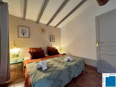 a bedroom with a bed with two towels on it at VILLA HORUS - Bergerie 1chambre - piscine privée in San-Gavino-di-Carbini
