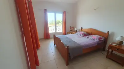 a bedroom with a bed and a window at Villa PIETRAROSSA in Lecci