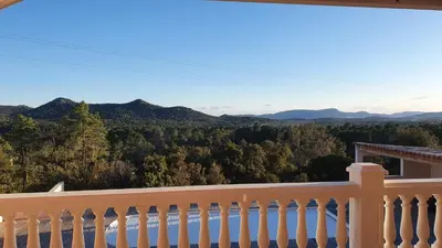 a balcony with a view of the mountains at Villa PIETRAROSSA in Lecci