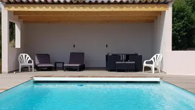a patio with chairs and a table and a pool at Villa PIETRAROSSA in Lecci