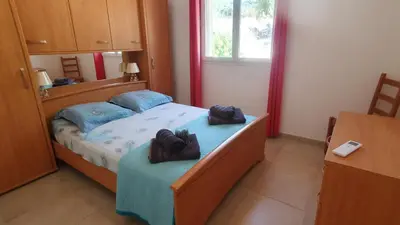 a bedroom with a bed with blue pillows at Villa PIETRAROSSA in Lecci