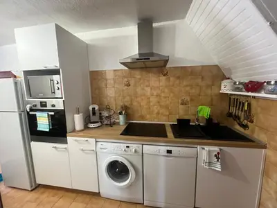 a kitchen with a sink and a washing machine at Traversa in Vezzani