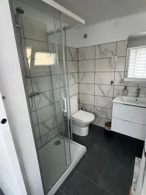 a bathroom with a shower and a toilet and a sink at Traversa in Vezzani