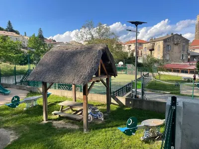 a pavilion with tables and surfboards on the grass at Traversa in Vezzani