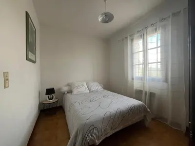 a white bedroom with a bed and a window at Traversa in Vezzani