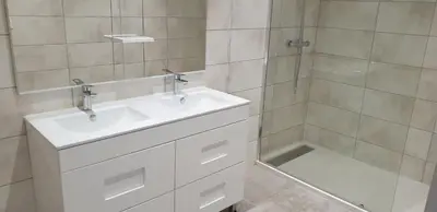 a bathroom with a white sink and a shower at Chez lili in Ghisonaccia