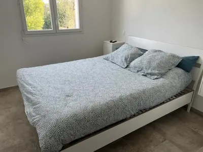 a bed with two pillows on it in a bedroom at Chez lili in Ghisonaccia