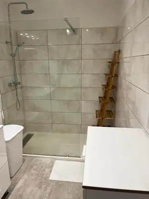 a bathroom with a shower with a glass door at Chez lili in Ghisonaccia