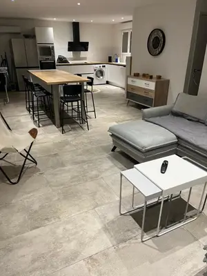 a living room with a couch and a table at Chez lili in Ghisonaccia