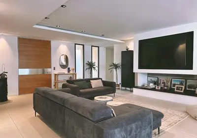 a living room with a couch and a flat screen tv at Villa Anjo in Zonza