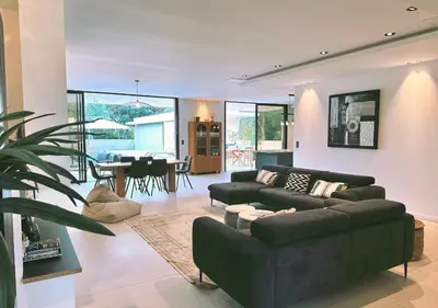a living room with a couch and a dining room at Villa Anjo in Zonza