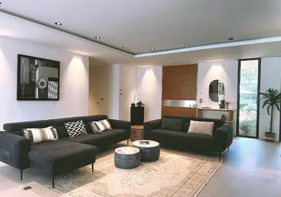 a living room with a black couch and a table at Villa Anjo in Zonza