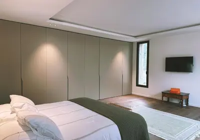 a bedroom with a bed and a flat screen tv at Villa Anjo in Zonza