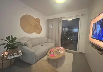 a living room with a couch and a tv at Studio Porto Vecchio centre in Porto-Vecchio