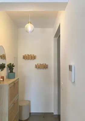 a room with a white wall with a light fixture at Studio Porto Vecchio centre in Porto-Vecchio