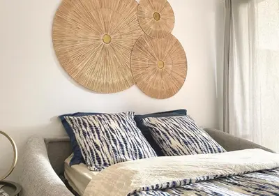 a living room with two wooden plates on the wall at Studio Porto Vecchio centre in Porto-Vecchio