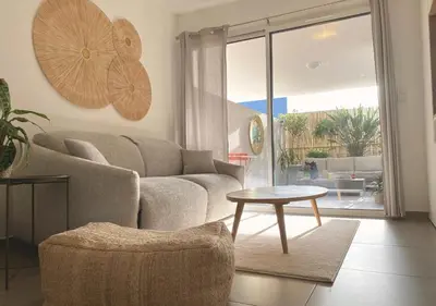a living room with a couch and a table at Studio Porto Vecchio centre in Porto-Vecchio