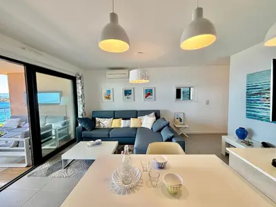 a living room with a couch and a table at Appartement 26 les terrasses de l'isolella Porticcio in Porticcio