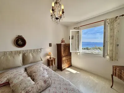 a bedroom with a bed and a large window at Appartement Le Panoria sanguinaires Ajaccio in Ajaccio
