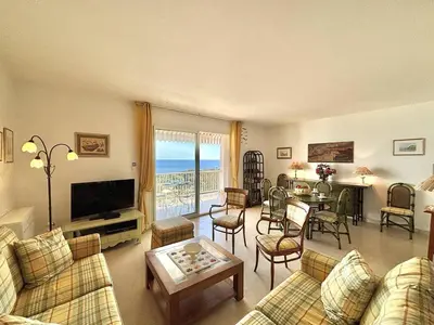 a living room with a couch and a table at Appartement Le Panoria sanguinaires Ajaccio in Ajaccio