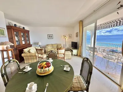 a living room with a table with a bowl of fruit on it at Appartement Le Panoria sanguinaires Ajaccio in Ajaccio