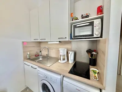 a small kitchen with a sink and a microwave at Appartement 317 Paesollu Porticcio in Porticcio