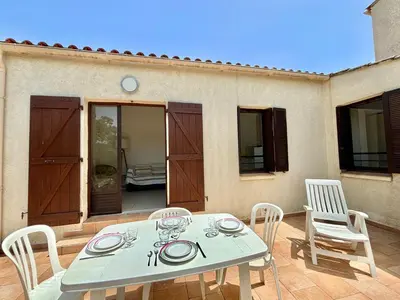 a white table and chairs on a patio at Appartement 317 Paesollu Porticcio in Porticcio