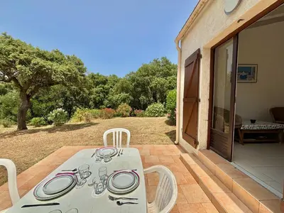 a white table and chairs on a patio at Appartement 317 Paesollu Porticcio in Porticcio