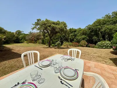 a white table with plates and wine glasses on it at Appartement 317 Paesollu Porticcio in Porticcio