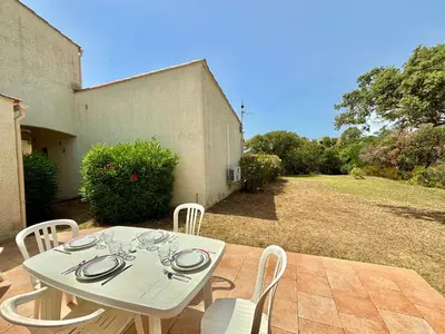 a white table and chairs on a patio at Appartement 317 Paesollu Porticcio in Porticcio