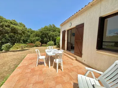 a patio with a table and chairs on it at Appartement 317 Paesollu Porticcio in Porticcio
