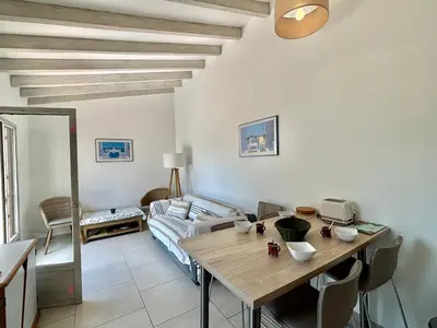 a living room with a table and a couch at Appartement 317 Paesollu Porticcio in Porticcio
