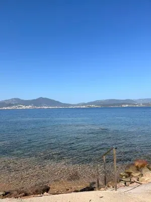 a large body of water with mountains in the background at closerie in Grosseto-Prugna