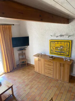 a living room with a table and a wooden counter at closerie in Grosseto-Prugna