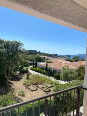 a balcony with a view of a garden and a building at closerie in Grosseto-Prugna