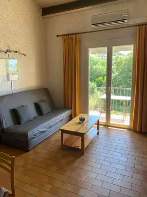 a living room with a couch and a coffee table at closerie in Grosseto-Prugna