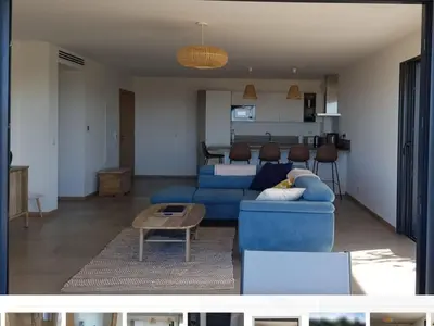 a patio with a table and a couch in a house at Porticcio - appartement T3 in Albitreccia