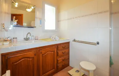 a bathroom with a sink and a toilet and a mirror at Maison Vue Mer Panoramique in Appietto