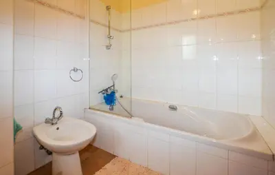 a bathroom with a toilet and a tub and a sink at Maison Vue Mer Panoramique in Appietto